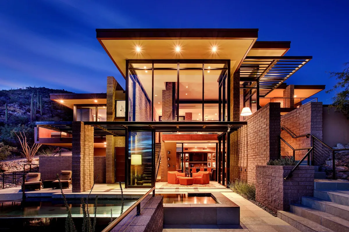 A modern house with a pool and a fire pit.